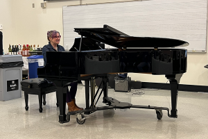 Woman plays piano.