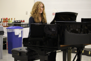 Woman plays piano.