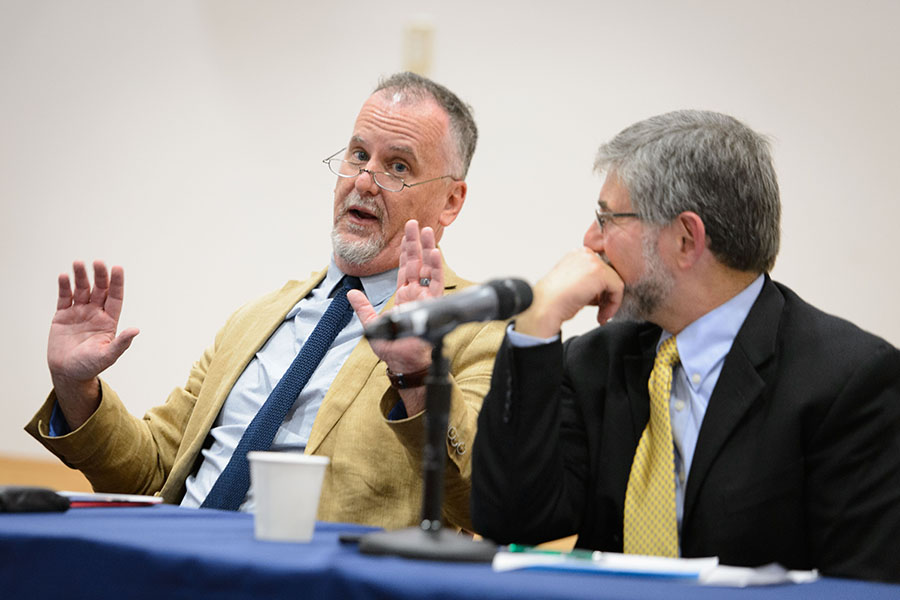 Michael Patrick Lynch, professor of philosophy and director of the UConn Humanities Institute, left, speaks during a panel discussion on the presidential election at an event held at the Hartford Public Library on Sept. 22, 2016. (Peter Morenus/UConn Photo)